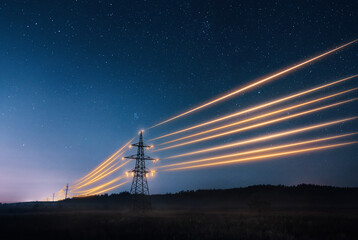 electricity transmission towers with orange glowing wires the starry night sky. energy infrastructur
