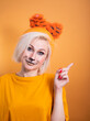 © Pavel Kovalevsky - A girl with tiger makeup on an orange background. Funny smiling. Tiger new year celebration
