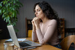 © DimaBerlin - Young focused businesswoman working on laptop at office desk, female accountant looking at monitor screen and analyzing statistical data, reading financial electronic document, female employee at work