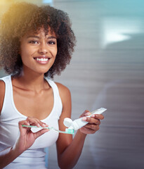 Canvas Print - I'm all about dental hygiene. Cropped portrait of a young woman brushing her teeth in the bathroom.