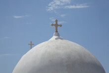 White Church Dome With Cross Sunny Day In Santorini, Greece