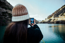 Girl Taking A Photo Of A Lake With Her Mobile
