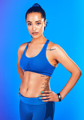 Poster - Confidence breeds results. Studio portrait of an attractive young sportswoman posing against a blue background.