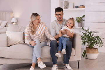 Sticker - Family with little daughter spending time together on sofa at home