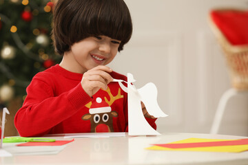 Poster - Cute little boy with paper angel for Saint Nicholas day at home