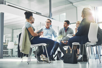 Poster - Everyone's ideas are important. Shot of a group of coworkers talking together while sitting in a circle in an office.