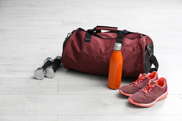 Wall Mural - Sports bag and gym stuff on white floor