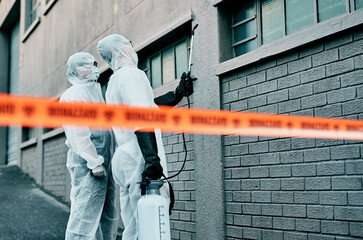 Poster - Those windows need to be secured. Shot of two healthcare workers wearing hazmat suits working together to control an outbreak.