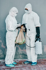 Aufkleber - The virus fighting unit. Shot of two healthcare workers wearing hazmat suits working together during an outbreak in the city.