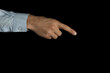 © New Africa - Man pointing at something on black background, closeup