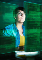 Poster - She's becoming part of the matrix. Cropped shot of a young computer programmer looking through data.