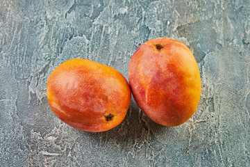 Wall Mural - Fresh mango on blue background. Beautiful homemade mango background