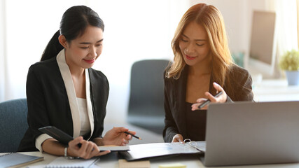 Wall Mural - Two businesswoman working together in the office.