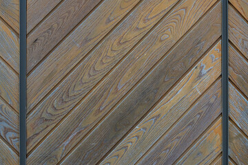 Close-up of a   brown wooden  wall  painted a very long time and the paint peeled off.  Brown texture background