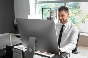 Poster - Handsome businessman working with computer at table in office