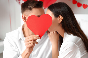 Beautiful young couple celebrating Valentine's Day at home