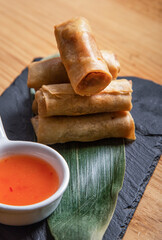 Photo of freshly cooked Filipino food called Shanghai Lumpiang or fried pork in spring roll wrapper.