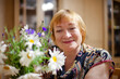 © DariaTrofimova - Old woman with wildflowers at home
