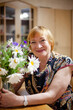 © DariaTrofimova - Portrait of   beautiful elderly woman with   bouquet of flowers.