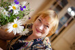 © DariaTrofimova - Old woman with wildflowers at home