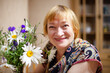 © DariaTrofimova - Portrait of   beautiful elderly woman with   bouquet of flowers.