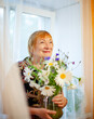 © DariaTrofimova - Portrait of   beautiful elderly woman with   bouquet of flowers.