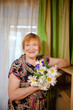 © DariaTrofimova - Portrait of   beautiful elderly woman with   bouquet of flowers.