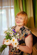 © DariaTrofimova - Old woman with wildflowers at home