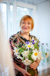 © DariaTrofimova - Portrait of   beautiful elderly woman with   bouquet of flowers.