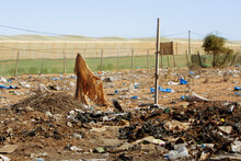 Photo Of Scattered Garbage On The Field. The Concept Of Waste Disposal And Environmental Pollution