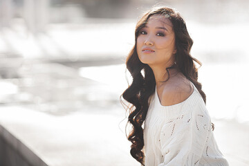 Wall Mural - Beautiful woman outdoors. Pretty lady on urban background. Asian female closeup portrait.