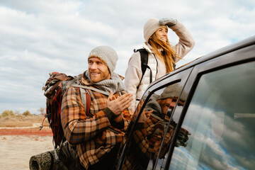 White happy couple smiling together during car trip