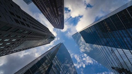 Wall Mural - Business and finance time lapse, looking up at modern office building architecture in the financial district of Toronto in Ontario, Canada.