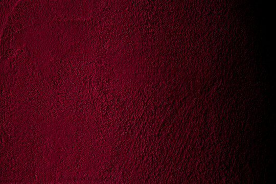 Crimson colored wall background with textures of different shades of crimson red