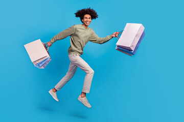 Canvas Print - Full body photo of young guy runner hurry shop discount store motion energetic isolated over blue color background