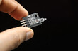 Mercury tilt switch sensor module held in hand isolated on black background, Electronic sensors for micro controllers