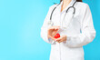 © Dmytro - Cardiology, heart care and health care concept with a cardiologist holding a figure of a heart in her hands.