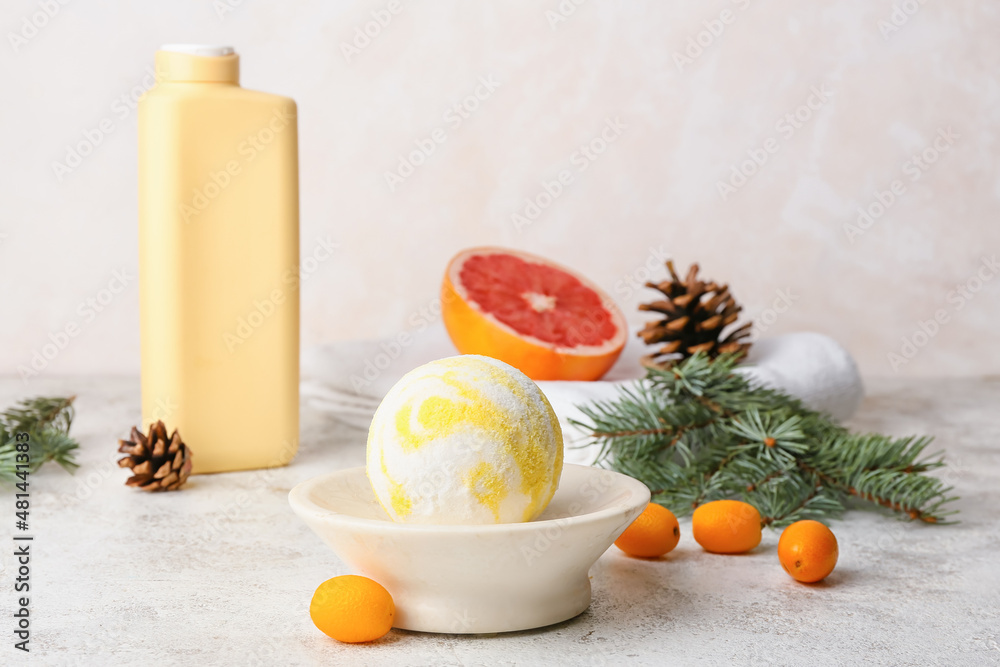 Composition with bath bomb, kumquat and fir branch on light background