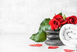 Fototapeta Kwiaty - Beautiful spa composition with stones and roses for Valentine's Day celebration on light background