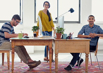 Poster - Getting down to designing. Shot of a group of creative professionals working in an office.