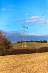 Wall Mural - High voltage power tower and beautiful nature landscape in the Czech countryside. Electricity distribution concept. Green deal. Clean energy.