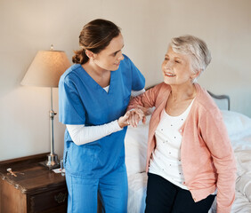 Sticker - I'm ready for a day out. Shot of a young nurse helping a senior woman get up from her bed in a nursing home.