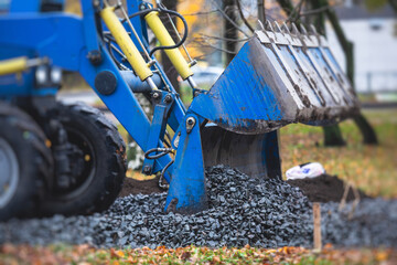 Wall Mural - Dump truck, tractor and bulldozer unloading gravel, road metal, rubble and crushed stone cement material during landscaping improvement and new pedestrian walk road construction site