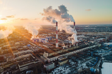 Wall Mural - Factory smokestack emissions at sunrise, climate change and global warming for the environment. Aerial view