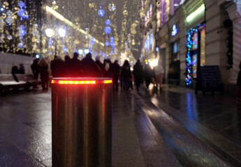 Festive holiday evening people festivities in the city on pedestrian area with illumination