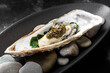 European oyster with black caviar and gold leaf.