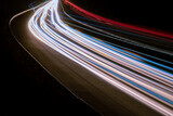 Fototapeta Przestrzenne - Night road lights. Lights of moving cars at night. long exposure red, blue, green, orange.