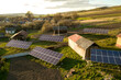 Aerial top down view of solar panels in green rural village yard.