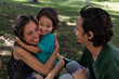 © Amilciar - Young Latino parents happily share with their 3 year old son at the park. Family concept.