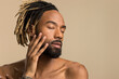 © Cultura Creative - Studio shot of young man with dreadlocks with closed eyes